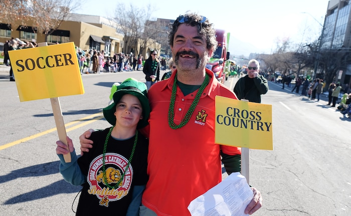 (Francisco Kjolseth | The Salt Lake Tribune) Matt Pacenza is joined by his son Maxwell as they join the fun as Salt Lake CityÕs Irish community celebrates their 41st annual St. PatrickÕs Day Parade with crowds lining up to take in the festivities. Marching bands, Irish dancers, bagpipes and a sea of green moved along 200 South, starting at 500 East Saturday morning en route to State street where the Siamsa festivities kept the fun going at the Gallivan Center.
