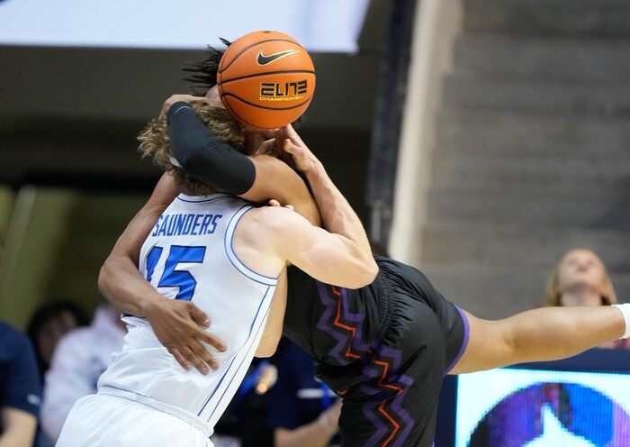 (Francisco Kjolseth | The Salt Lake Tribune) Brigham Young Cougars guard Richie Saunders (15) intertwines with TCU Horned Frogs forward Chuck O'Bannon Jr. (5) during an NCAA college basketball game against TCU Saturday, March 2, 2024, in Provo, Utah.