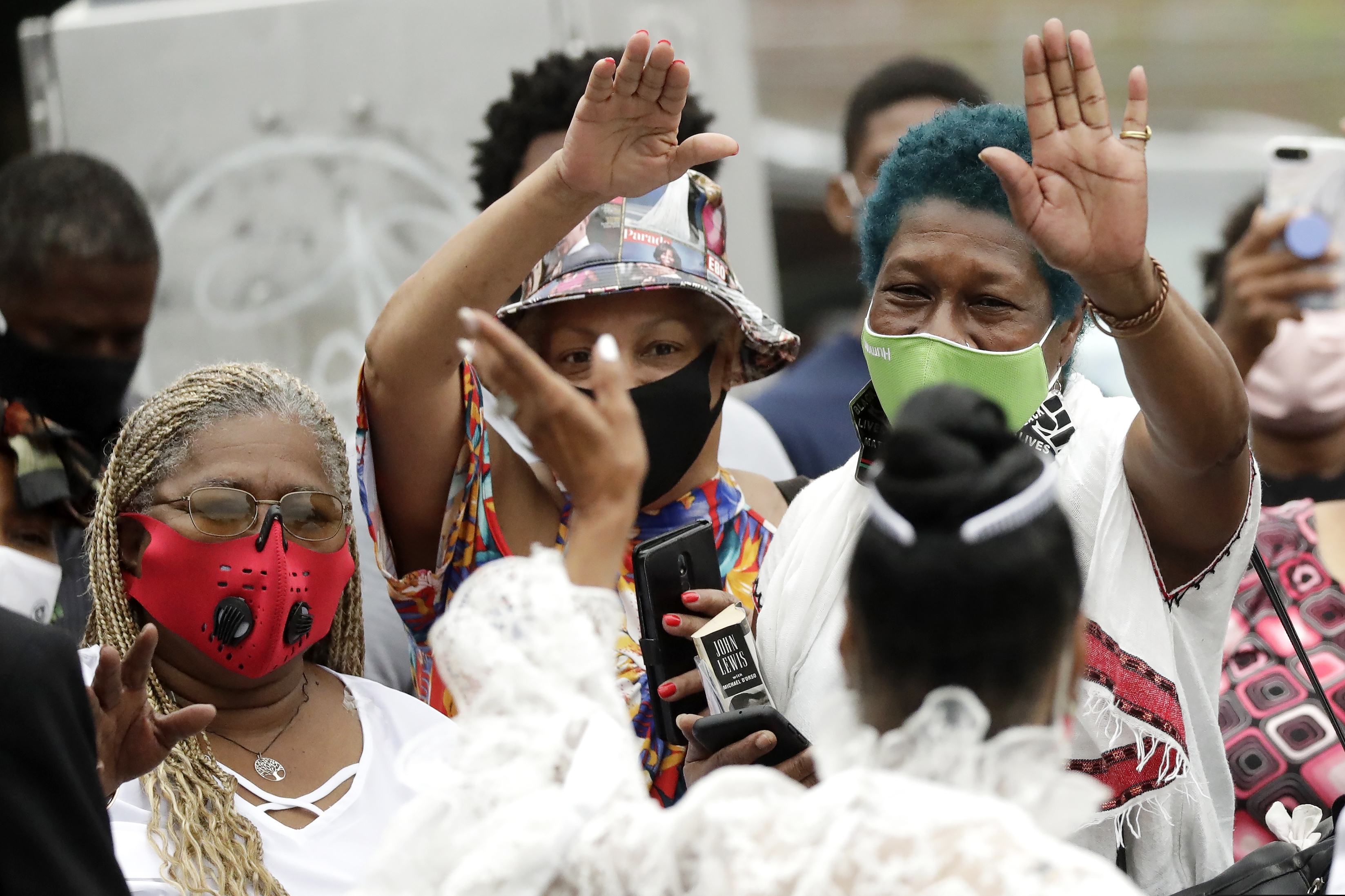 Mourners stand outside Ebenezer Baptist Church during the funeral for Rep. John Lewis at , Thursday, July 30, 2020, in Atlanta. Lewis, who carried the struggle against racial discrimination from Southern battlegrounds of the 1960s to the halls of Congress, died Friday, July 17, 2020. (AP Photo/Brynn Anderson)