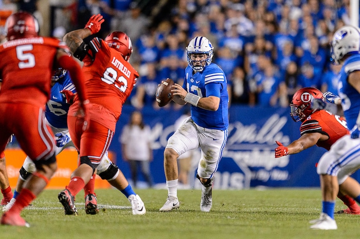 (Trent Nelson | The Salt Lake Tribune)  Brigham Young Cougars quarterback Tanner Mangum (12) is pressured as BYU hosts Utah, NCAA football in Provo, Saturday September 9, 2017.