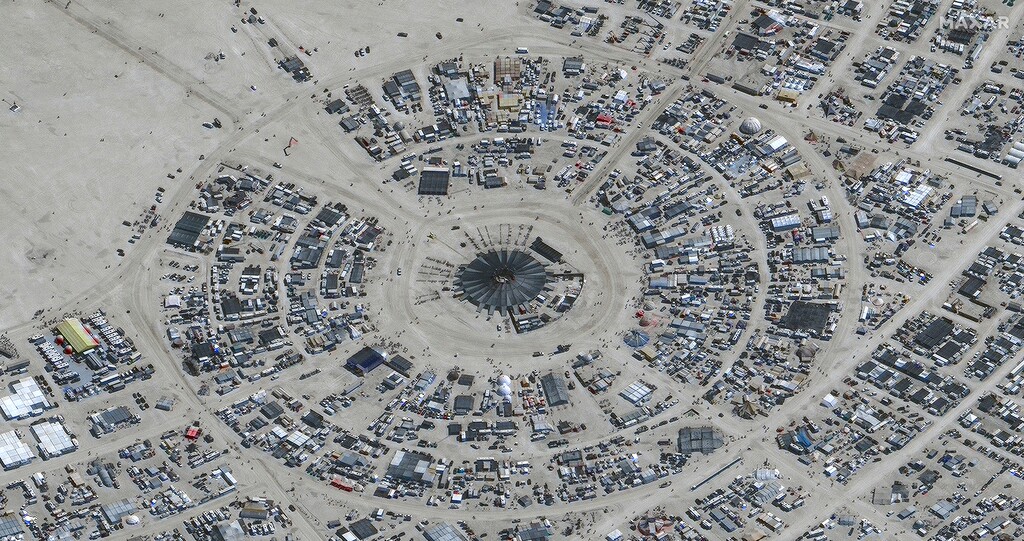 (Maxar Technologies  |  via The Associated Press) In this satellite photo provided by Maxar Technologies, an overview of Burning Man festival in Black Rock, Nev on Monday, Aug. 28, 2023.