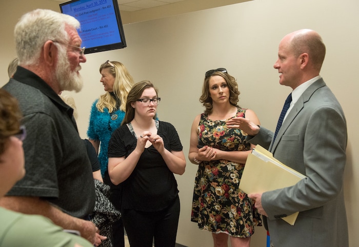 (Rick Egan  |  The Salt Lake Tribune)       Chad Grunander deputy Utah County attorney talks to family members  Riley and Breezy, after Jerrod Baum appeared for a hearing in Provo. He is accused of killing 18-year-old Riley Powell and 17-year-old Brelynne “Breezy” Otteson in December and dumping their bodies into an abandoned mine shaft. Thursday, April 26, 2018.   

