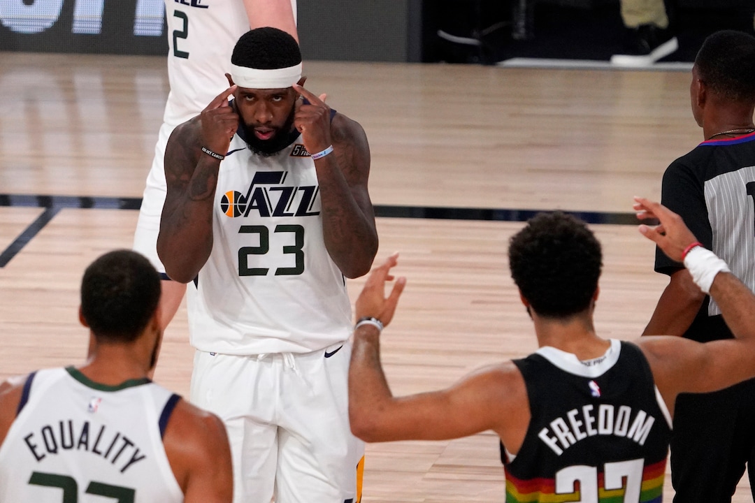Utah Jazz's Royce O'Neale (23) celebrates with Rudy Gobert, bottom left, as Denver Nuggets' Jamal Murray (27) gestures following the foul call against his team after Gobert sunk a basket during the second half an NBA first round playoff basketball game, Tuesday, Sept. 1,2020, in Lake Buena Vista, Fla. (AP Photo/Mark J. Terrill)