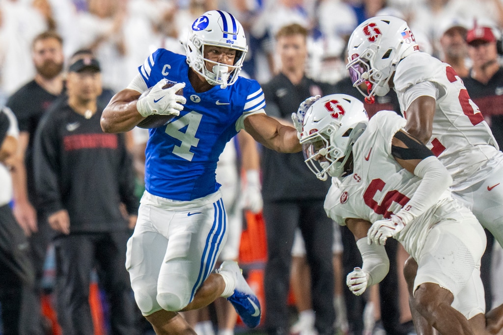 (Rick Egan | The Salt Lake Tribune) Brigham Young Cougars running back LJ Martin (4) runs for a huge gain as Stanford Cardinal cornerback Collin Wright (6) defends in football action between the Brigham Young Cougars and the Stanford Cardinal, at Lavell Edwards Stadium on Saturday Sept. 6, 2025.