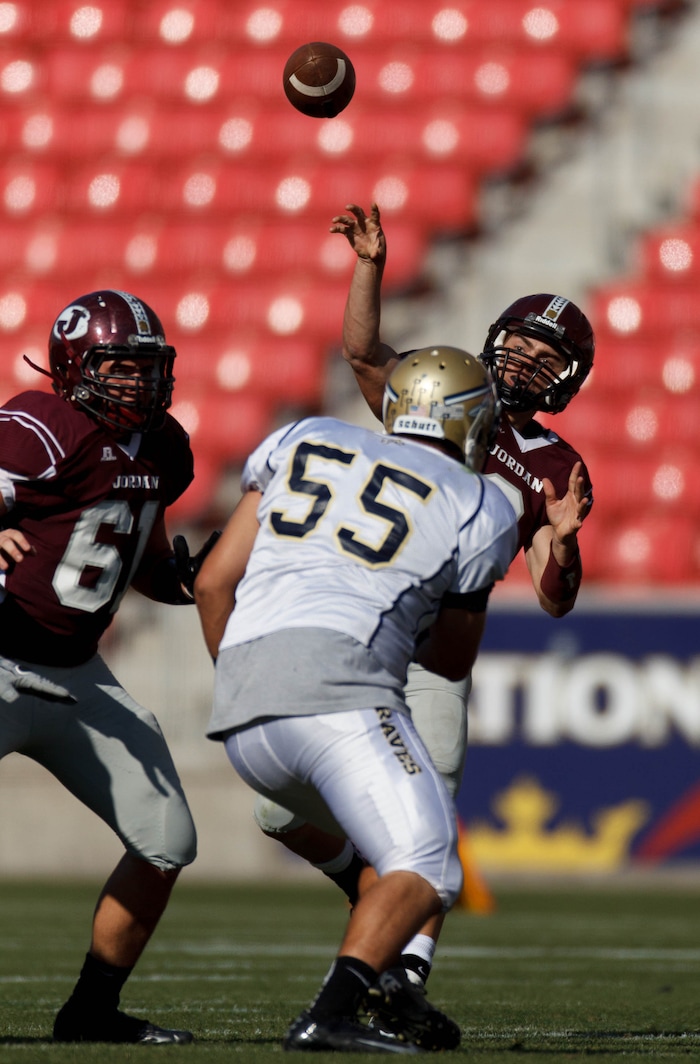 (Trent Nelson  |  The Salt Lake Tribune)  Jordan lineman Ian Moes (61) protects quarterback Austin Kafentzis as he throws a pass as Jordan High School faces St. John Bosco (CA) football Saturday September 29, 2012 in the Xfinity High School Football Challenge at Rio Tinto Stadium in Sandy, Utah.