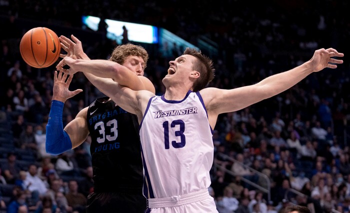 (Francisco Kjolseth | The Salt Lake Tribune) Brigham Young Cougars forward Caleb Lohner (33) blocks Westminster Griffins forward Brayden Johnson’s (13) drive to the basket in basketball action between the Brigham Young Cougars and the Westminster Griffins at the Marriott Center in Provo, Wednesday, Dec. 29, 2021.