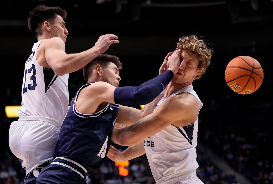 (Francisco Kjolseth | The Salt Lake Tribune) Utah State Aggies guard Rylan Jones (15), center, gets pressured by Brigham Young Cougars guard Alex Barcello (13) and Brigham Young Cougars forward Caleb Lohner (33) in basketball action between the Brigham Young Cougars and the Utah State Aggies at the Marriott Center in Provo, Wednesday, Dec. 8, 2021.