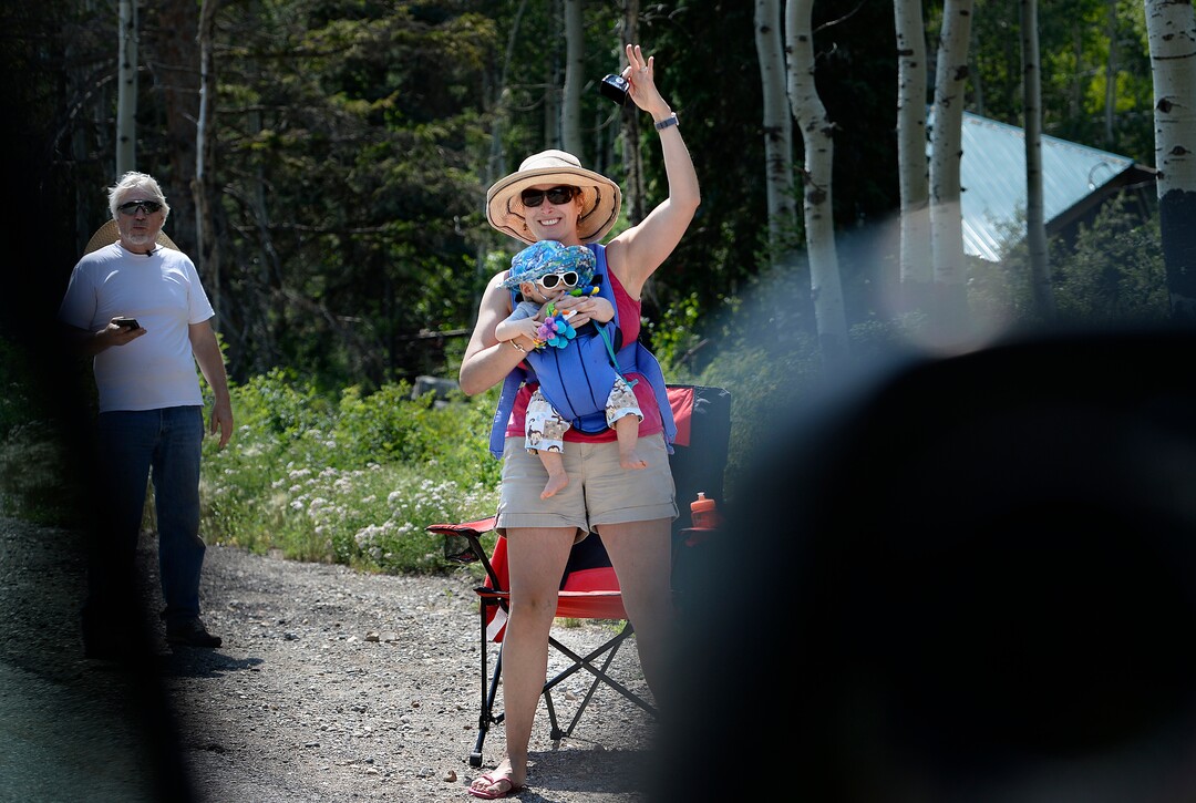 (Scott Sommerdorf   |  The Salt Lake Tribune)   A fan with a baby attached waves from the side of the course during Stage 3 of the Tour of Utah in Big Cottonwood Canyon, Wednesday, August 2, 2017.  