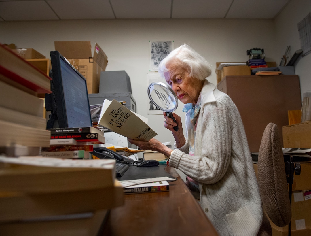 (Leah Hogsten | The Salt Lake Tribune)  Lila Weller uses a magnifying glass to help her read as she logs books into a computer at Weller Book Works, August 7, 2019. Weller Book Works — formerly Zion Bookstore and Sam Weller's Books — is celebrating its 90th year.