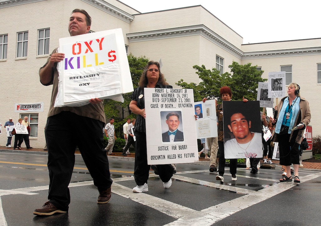 (David Crigger | Bristol Herald Courier via AP file) Ed Bisch, left, and other demonstrators march along Main Street in Abingdon, Va., to raise awareness about the abuse of OxyContin in July 2007.