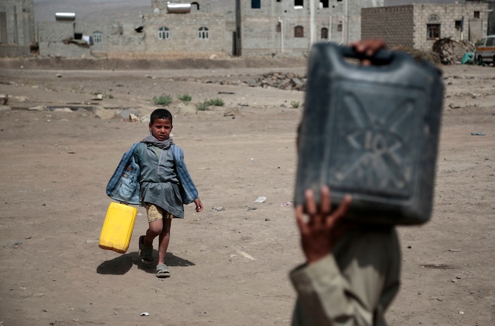 In this photo taken on Wednesday, Jul. 12, 2017, boys carry buckets to fill with water from a well that is alleged to be contaminated water with the bacterium Vibrio cholera, on the outskirts of Sanaa, Yemen. Yemen’s raging two-year conflict has served as an incubator for lethal cholera. (AP Photo/Hani Mohammed)