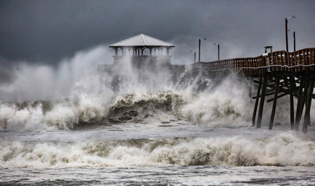 Waves slam the Oceana Pier & Pier House Restaurant in Atlantic Beach, N.C.,  Thursday, Sept. 13, 2018 as Hurricane Florence approaches the area. (Travis Long/The News & Observer via AP)