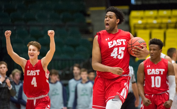 (Rick Egan  |  The Salt Lake Tribune)   East Leopards East Leopards Taylor Zwick (4) Mikey Frazier (45) and East Leopards Jaylon Vickers (10) celebrate East High's 54-53 win over the Jordan Beatdiggers, in 5A basketball playoff action at the UCCU Center in Orem, Monday, Feb. 26, 2018.