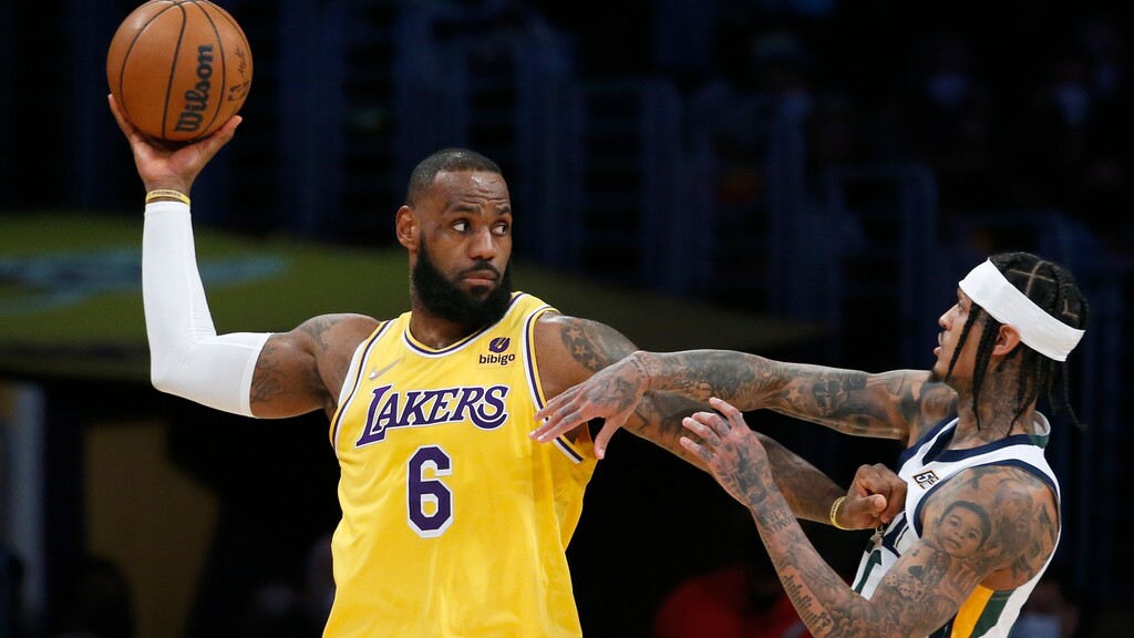 Los Angeles Lakers forward LeBron James (6) is defended by Utah Jazz guard Jordan Clarkson, right, during the first half of an NBA basketball game in Los Angeles, Monday, Jan. 17, 2022. (AP Photo/Ringo H.W. Chiu)