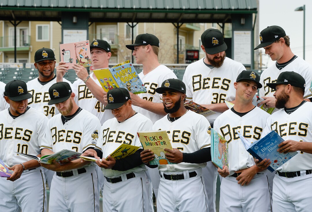 (Francisco Kjolseth  |  The Salt Lake Tribune)  The Salt Lake Bees gather for a group portrait for the start of their season during Media Day on Tuesday, April 2, 2019. Holding kids books for staff pictures to be used later in the season as part of a program to get kids to finish their Summer reading goals, the Bees will offer a free ticket. 