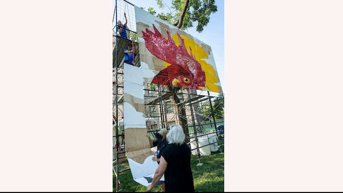 (Rick Egan | The Salt Lake Tribune) Alexis Rose, Marsha, Dave and Mason Fetzer hang the PZLMRL, a puzzle mural, in which 100 artists painted 100 squares to make a puzzle mural, at the Salt Lake Arts Festival, on Saturday, Aug. 28, 2021.
