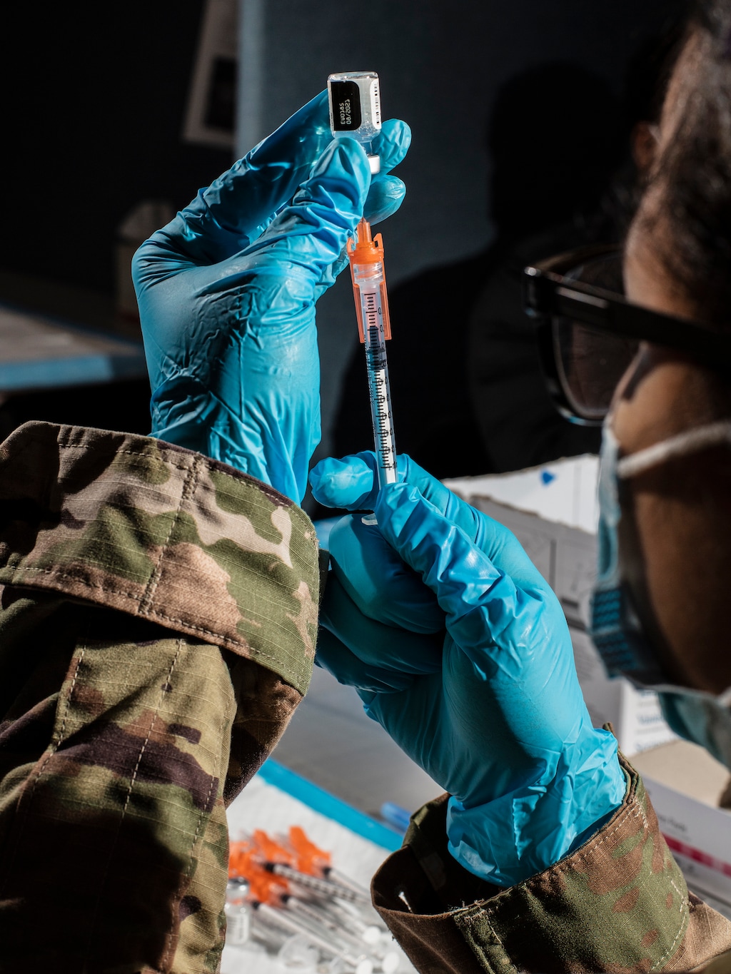 (Bryan Anselm | The New York Times)
A member of the United States military prepares doses of the Pfizer-BioNTech COVID-19 vaccine at New Jersey Institute of Technology in Newark, N.J., on June 19, 2021. "I worry that by dragging the vaccines further into the partisan mire, Biden's slip-up will cause long-term damage in the effort to get Americans to trust these miraculous shots," writes The New York Times opinion columnist Farhad Manjoo.
