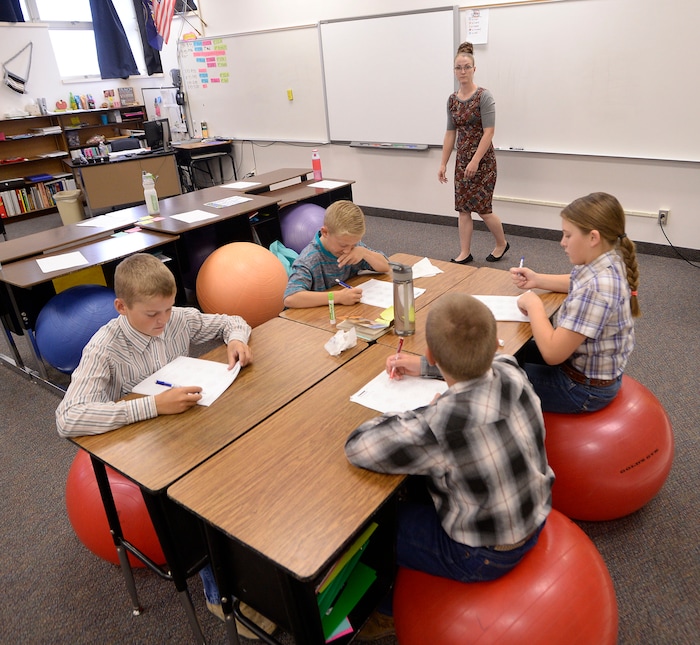 (Al Hartmann | The Salt Lake Tribune) Teacher Hallie Kunzler works with 6th grade class on double digit factor puzzles Wednesday August 30. She is one of two full-time teachers and a handful of teacher's aids at Park Valley School . The staff wear many hats teaching different subjects and grade levels.