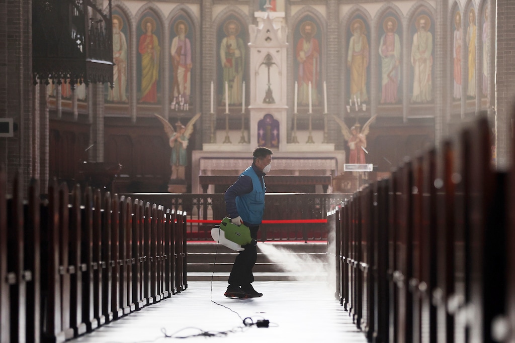 (Lee Ji-eun | Yonhap via AP) A worker wearing a face mask sprays disinfectant as a precaution against the new coronavirus at Myeongdong Cathedral in Seoul, South Korea, Wednesday, Feb. 26, 2020. The number of new virus infections in South Korea jumped again Wednesday and the U.S. military reported its first case among its soldiers based in the Asian country, with his case and many others connected to a southeastern city with an illness cluster.