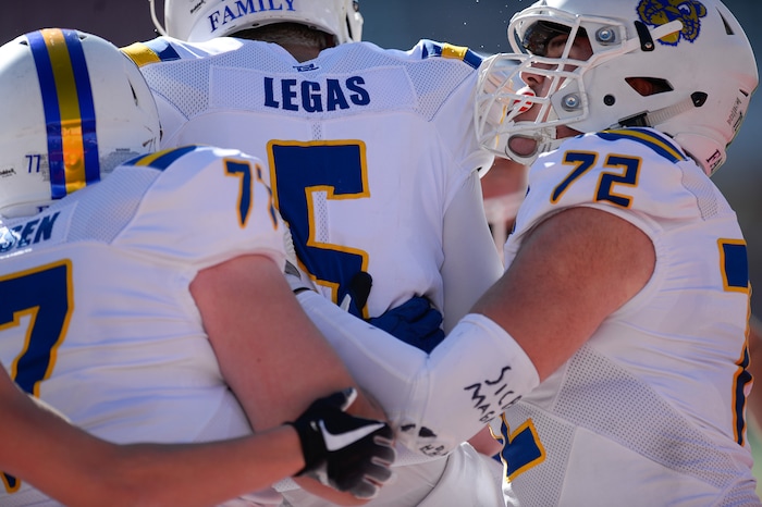 (Francisco Kjolseth  |  The Salt Lake Tribune)  Orem quarterback Cooper Legas is celebrated by teammates after running in a touchdown over Dixie in the 4A high school championship game at Rice Eccles Stadium in Salt Lake City, Friday, Nov. 16, 2018.