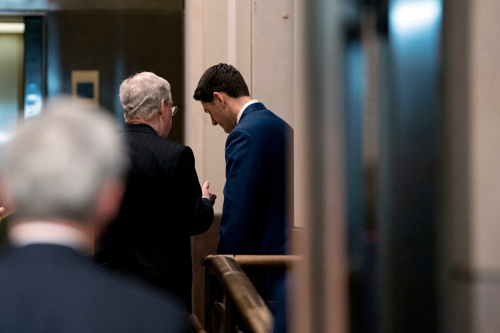 Senate Majority Leader Mitch McConnell of Kentucky, left, speaks with House Speaker Paul Ryan of Wisconsin, right, behind closed doors after a Congressional Gold Medal Ceremony honoring the Office of Strategic Services in Emancipation Hall on Capitol Hill in Washington, Wednesday, March 21, 2018. (AP Photo/Andrew Harnik)