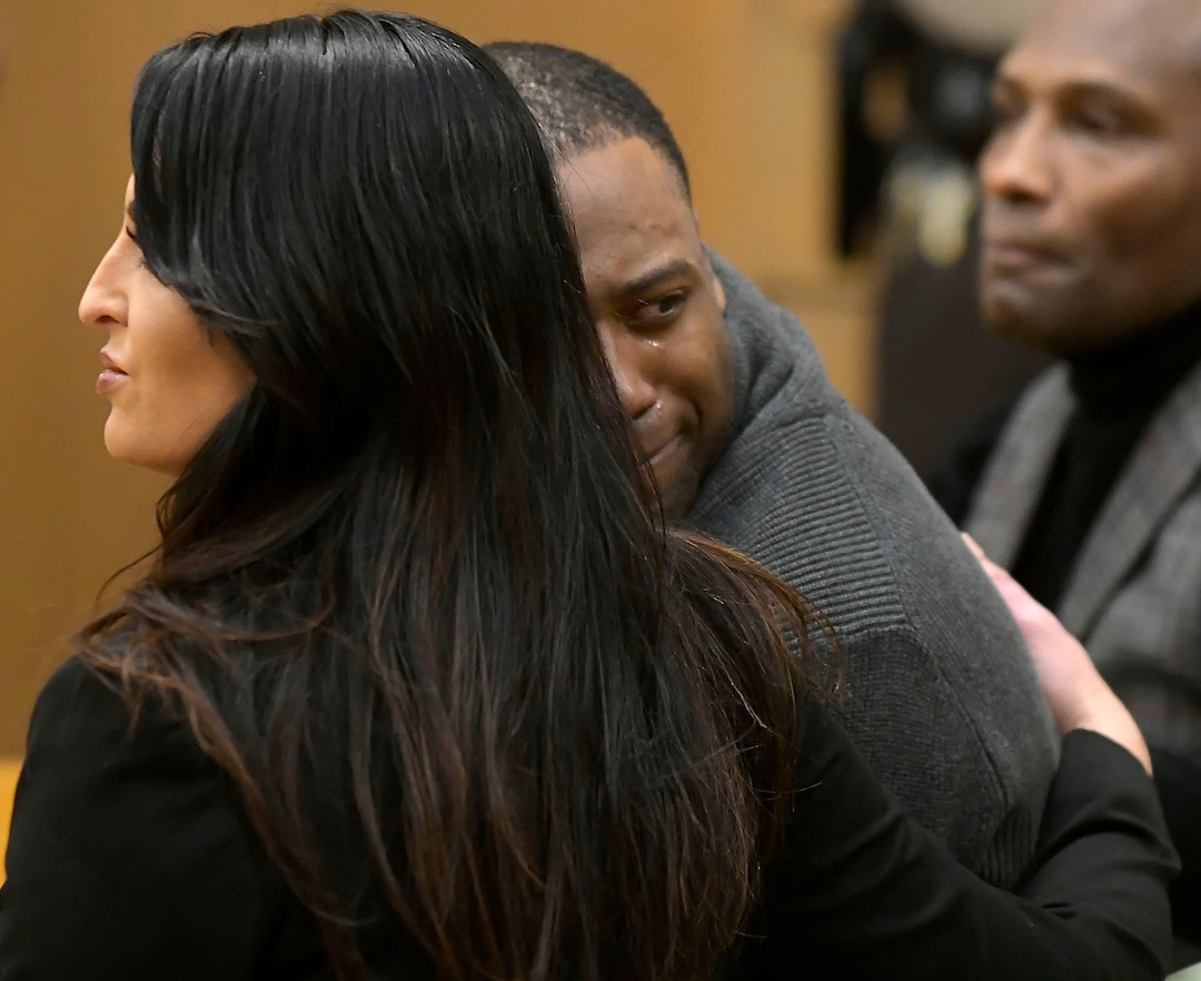 Torrey Green looks back at his family while being consoled by defense attorney Skye Lazaro, after a jury finds him guilty of eight charges including five counts of rape and a charge sexual battery in connection to reports from six women accusing him of sexual assault while he was a football player at Utah State University, Friday, Jan.18, 2019 in Brigham City, Utah. (Eli Lucero/Herald Journal via AP)
