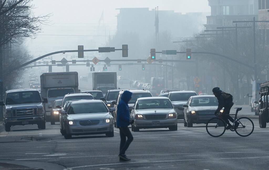 (Al Hartmann  |  The Salt Lake Tribune) 	Traffic and pedestrians on State Street at 300 S. Monday Dec. 11. Winters first temperature inversion with it associated polluted air has arrived in Northern Utah.