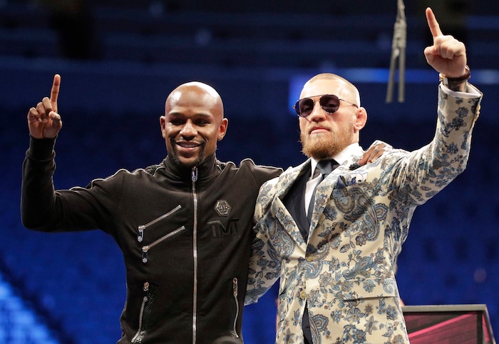 (AP Photo | Isaac Brekken) Floyd Mayweather Jr., left, and Conor McGregor pose during a news conference after a super welterweight boxing match Sunday, Aug. 27, 2017, in Las Vegas.