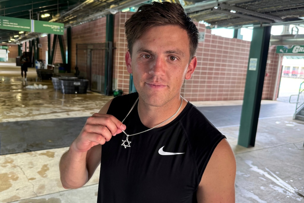 (Brett Martel | AP) New Tulane quarterback Jake Retzlaff, a transfer from BYU, shows off the Star of David on his necklace after football practice at Yulman Stadium in New Orleans, on Friday, Aug. 1, 2025.