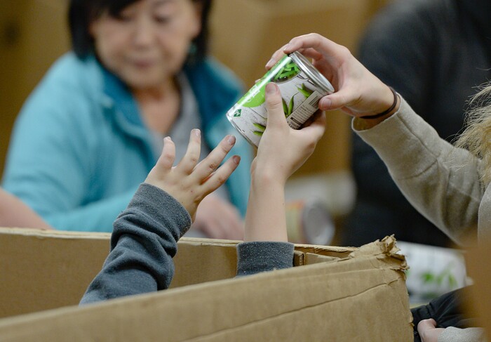 (Francisco Kjolseth  |  The Salt Lake Tribune) Owen Rogers, 10, helps unload the bottom of a large box of donated food to help celebrate the 2020 Martin Luther King Jr. Day of Service by volunteering at Utah Food Bank on Monday, Jan. 20, 2020.