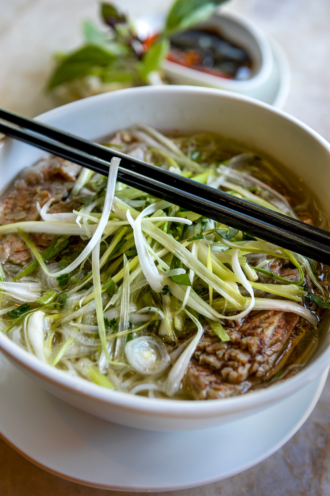 (Leah Hogsten  |  The Salt Lake Tribune)  Saola dish of the week is brisket pho, made with a clear aromatic broth poured over rice noodles, onion, cilantro and scallion, $15. Saola restaurant, located in Cottonwood Heights, serves Vietnamese food using locally sourced ingredients.