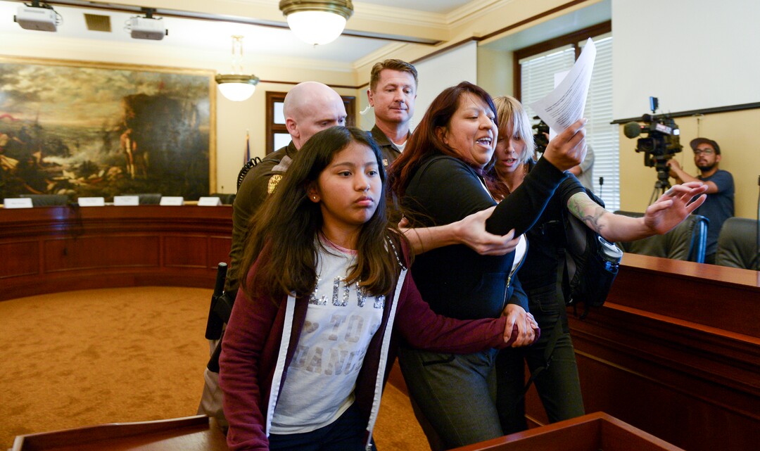 (Leah Hogsten  |  The Salt Lake Tribune) Opponents of the proposed inland port are escorted out of the Utah Inland Port Authority Board meeting by Utah Highway Patrol officers at the Capitol, June 5, 2019. The Inland Port Authority Board had to cancel its meeting last month after a group of protesters took over the meeting.