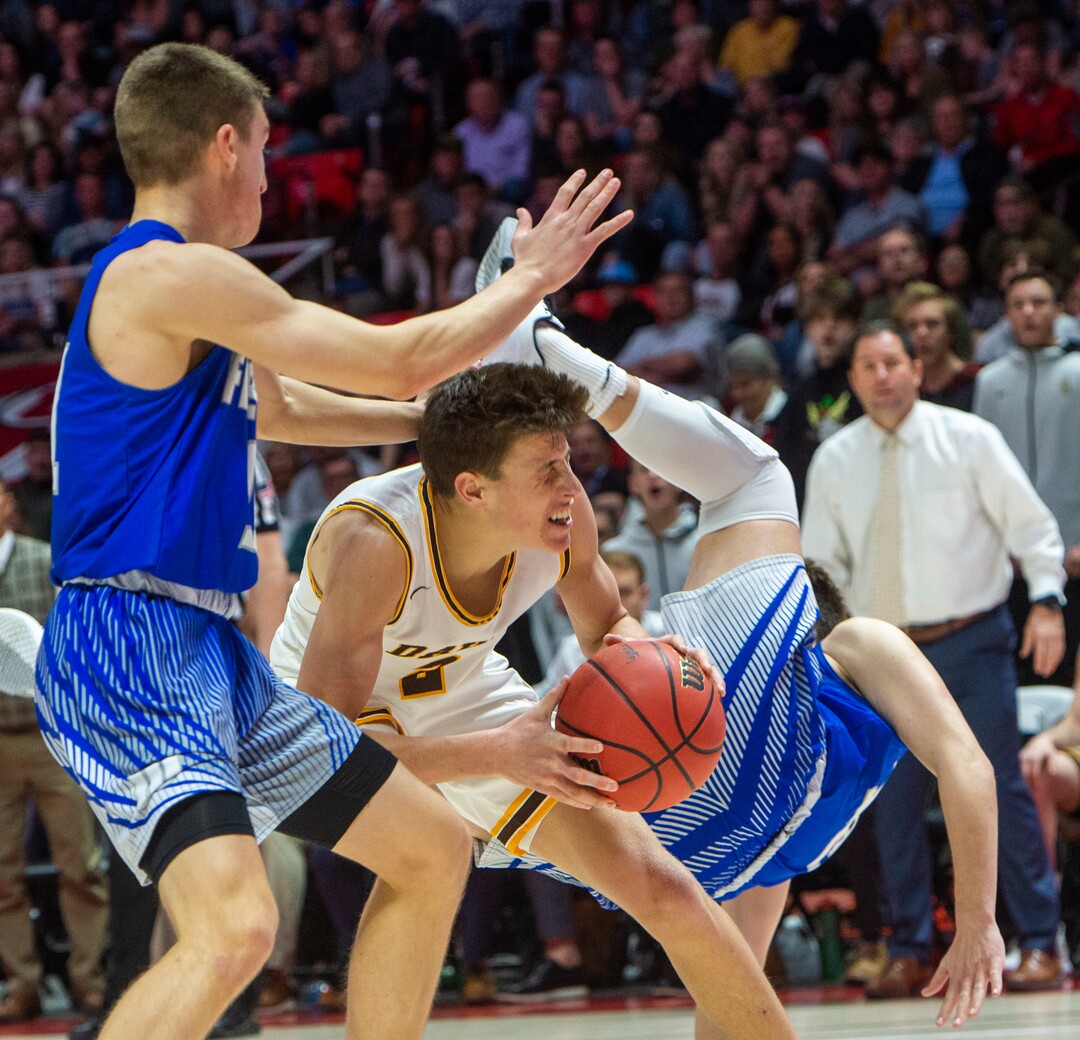 (Rick Egan  |  The Salt Lake Tribune)   Fremont Silverwolves Mitch Stratford (12)   lands onto of Davis High forward Spencer Vernon (2), in the 6A championship game at the Jon M. Huntsman Center, Saturday Feb. 29, 2020