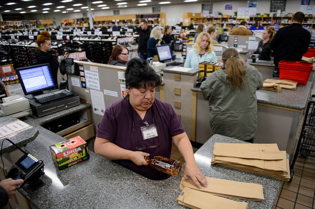 (Trent Nelson | The Salt Lake Tribune)  Cynthia Garcia working at the liquor store in Sandy on Tuesday Nov. 20, 2018. Liquor sales on the days leading up to Thanksgiving are expected to hit another record this year.