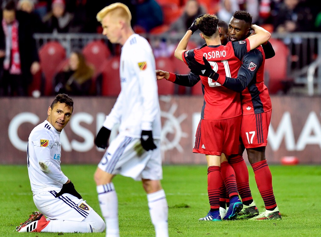Toronto FC forward Jozy Altidore (17) celebrates his second goal with teammate Jonathan Osorio (21) during first-half MLS soccer game action against Real Salt Lake in Toronto, Friday, March 30, 2018. (Frank Gunn/The Canadian Press via AP)