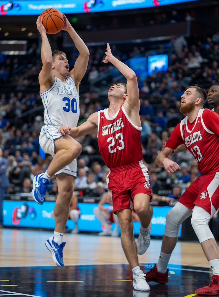 (Rick Egan | The Salt Lake Tribune)  South Dakota Coyotes guard Paul Bruns (23) guards Brigham Young Cougars guard Dallin Hall (30), in basketball action between the Brigham Young Cougars and the South Dakota Coyotes, at Vivint Arena, in Salt Lake City, on Saturday, Dec. 3, 2022.
