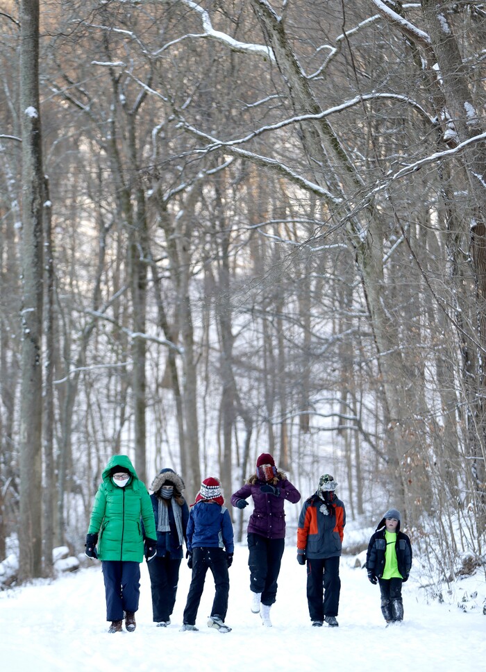 People take a walk in the snow at Radnor Lake State Park, Tuesday, Jan. 16, 2018, in Nashville, Tenn. A winter storm brought snow and cold temperatures to the area, causing the closing of schools and businesses. (AP Photo/Mark Humphrey)