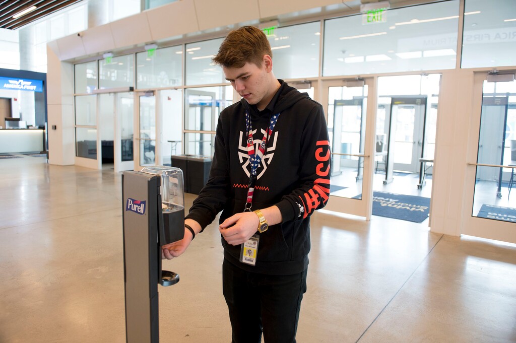 (Jeremy Harmon | The Salt Lake Tribune) Larry H. Miller Sports and Entertainment employee Samuel Barlow washes his hands at a hand sanitizer station at Vivint Smart Home Arena ahead of a game between the Jazz and the Raptors on Monday, March 9, 2020.