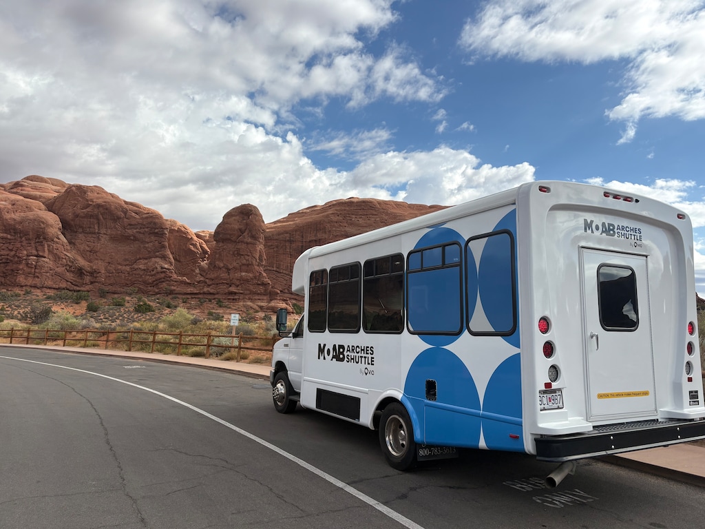 (Andrew Christiansen | The Times-Independent) A Moab-Arches shuttle is parked at The Windows in Arches National Park on Sept. 1, the first day of the system’s public soft launch. The free service connects Moab with the Arches Visitor Center, Delicate Arch and The Windows.