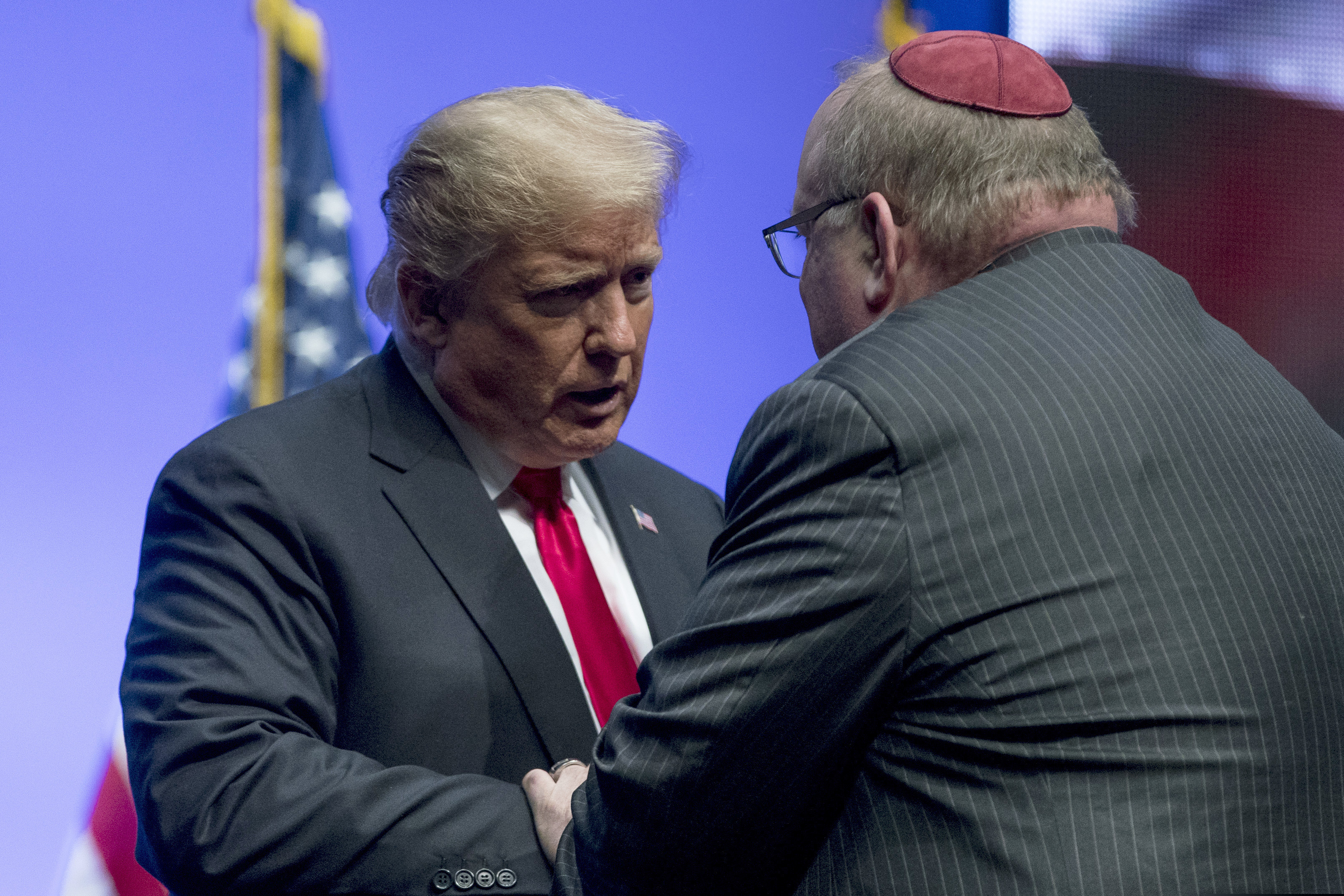 President Donald Trump embraces Rabbi Benjamin Sendrow after he prays at the 91st annual Future Farmers of America Convention and Expo at Bankers Life Fieldhouse in Indianapolis, Saturday, Oct. 27, 2018, following a shooting in a Pittsburgh synagogue. (AP Photo/Andrew Harnik)