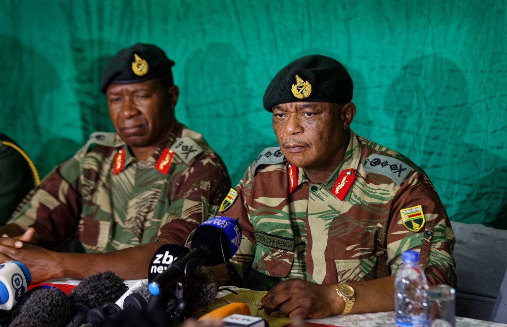 Zimbabwean Army General Constantino Chiwenga, right, speaks to the media at KG6 barracks in Harare, Zimbabwe Monday, Nov. 20, 2017.   The military has had President Robert Mugabe under house arrest for several days, and urged for calm. (AP Photo/Ben Curtis)
