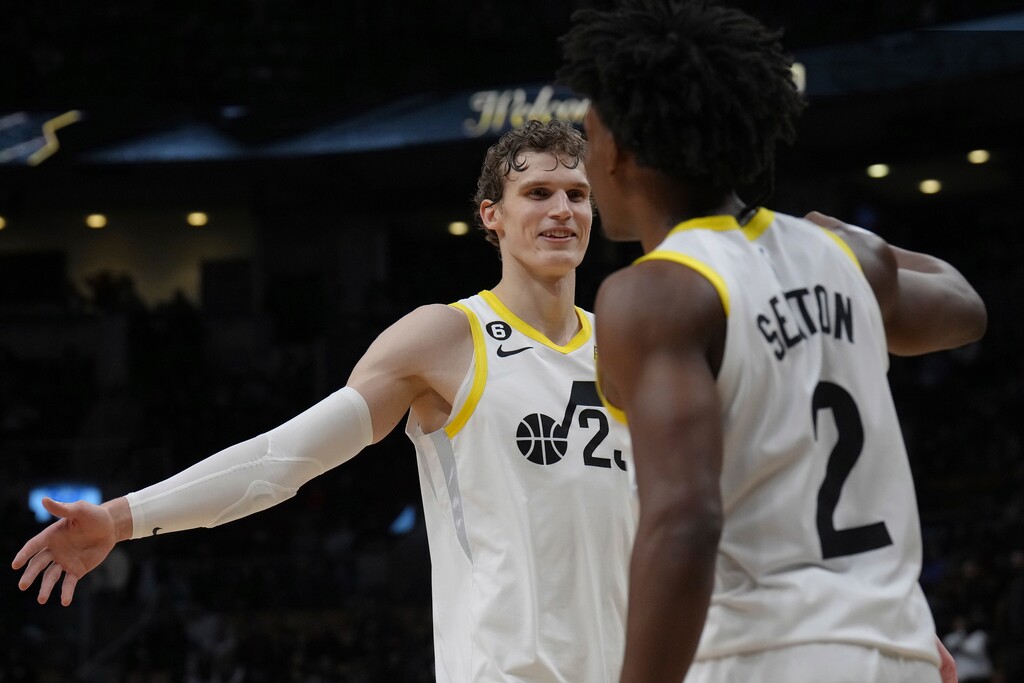 Utah Jazz's Lauri Markkanen, left, and Collin Sexton celebrate near the end of the team's win over the Toronto Raptors in an NBA basketball game Friday, Feb. 10, 2023, in Toronto. (Chris Young/The Canadian Press via AP)