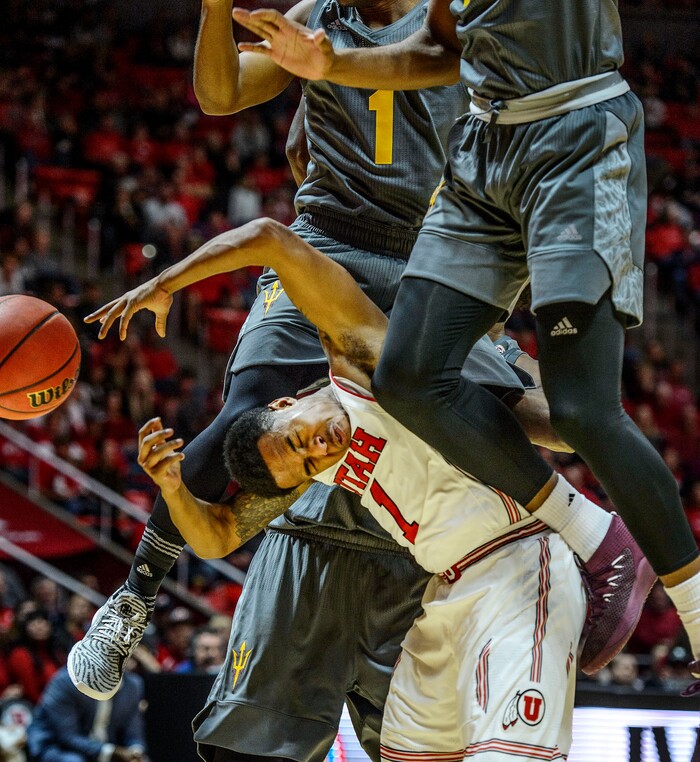 (Steve Griffin  |  The Salt Lake Tribune) Arizona State Sun Devils guard Remy Martin (1) and Arizona State Sun Devils forward Kimani Lawrence (14) crash down onto the head of Utah Utes guard Justin Bibbins (1) after Bibbins pump faked them both into the air during the Utah Utes versus Arizona State Sun Devils at the Huntsman Center on the University of Utah campus in Salt Lake City Sunday January 7, 2018.