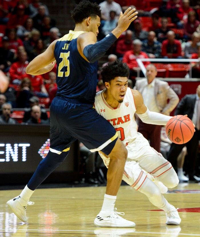 (Steve Griffin  |  The Salt Lake Tribune)  Utah Utes guard Sedrick Barefield (0) drives under UC Davis Aggies forward A.J. John (25) during the Utah versus UC Davis men's NIT basketball game at the Huntsman Center in Salt Lake City Wednesday March 14, 2018.