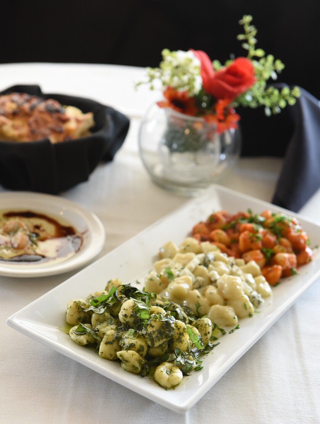 (Francisco Kjolseth  |  The Salt Lake Tribune)  Homemade pesto, creamy gorgonzola and tomato basil gnocchi with fresh baked bread at Per Noi Trattoria, a popular Italian restaurant in Salt Lake City, that just opened a second location at 8657 S. Highland Drive in Sandy.