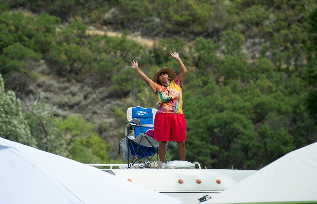 (Rick Egan  |  The Salt Lake Tribune)     Debi Roan, from Tuba City Arizona, moves to the reggae music  as she dances on top of a motor home, as the band Iya Terra performs at the Reggae Rise Up Music Festival, at the Rivers Edge near Heber City. Saturday, Aug. 25, 2018.