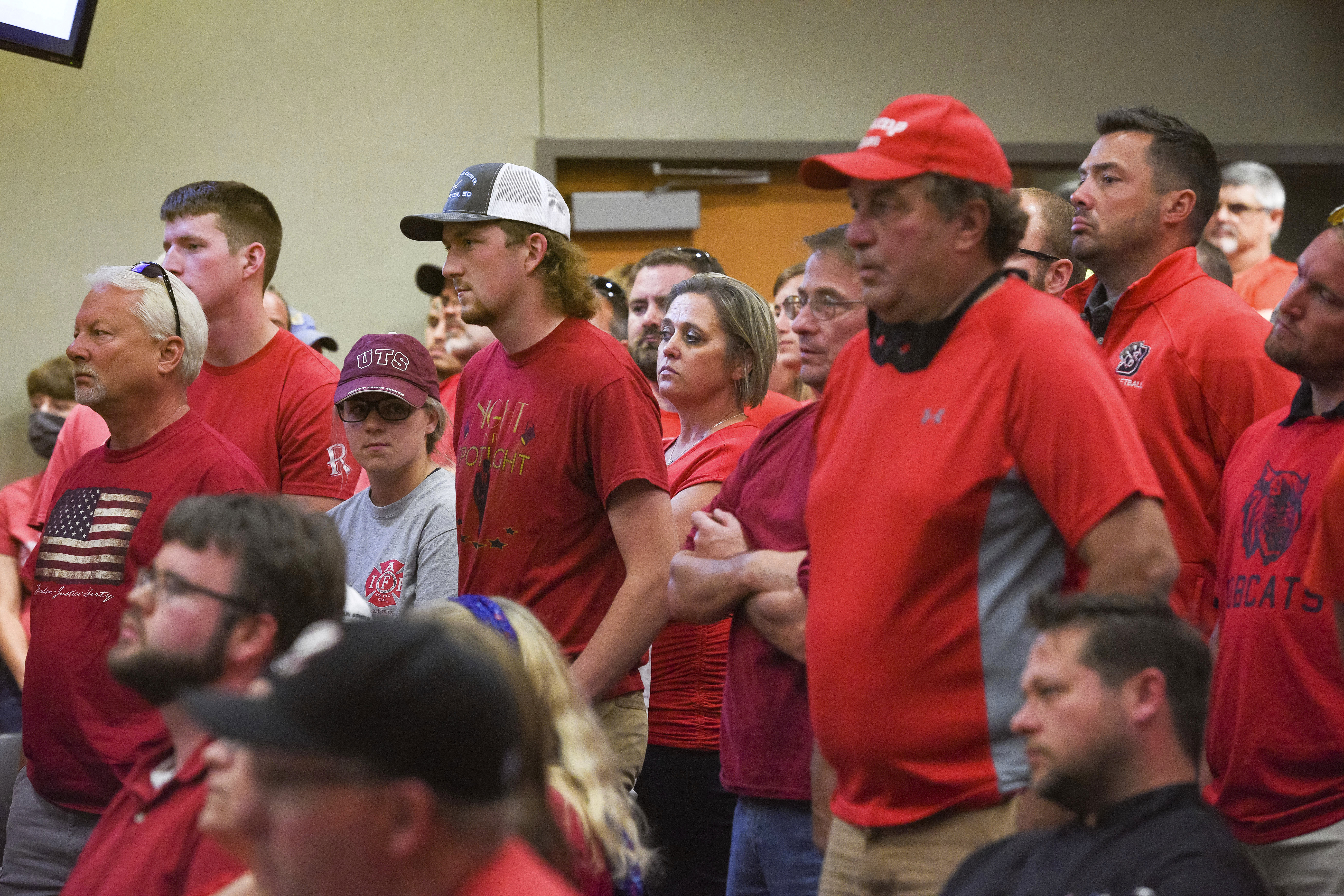 People wear red in solidarity against a potential city-wide mask mandate during a city council meeting on Wednesday, Sept. 2, 2020, in Brookings, S.D. Coronavirus infections in the Dakotas are growing faster than anywhere else in the nation, fueling impassioned debates over masks, personal responsibility and freedom after months in which the two states avoided the worst of the pandemic. (Erin Bormett/The Argus Leader via AP)