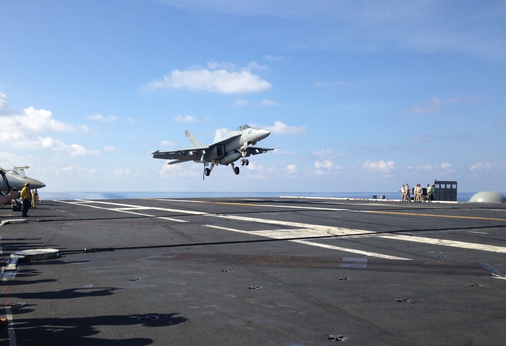 An FA-18 jet fighter lands on the USS John C. Stennis, aircraft carrier in the South China Sea on Friday, April 15, 2016. U.S. Defense Secretary Ash Carter visited the aircraft carrier during a trip to the region. (AP Photo/Lolita C. Baldor)