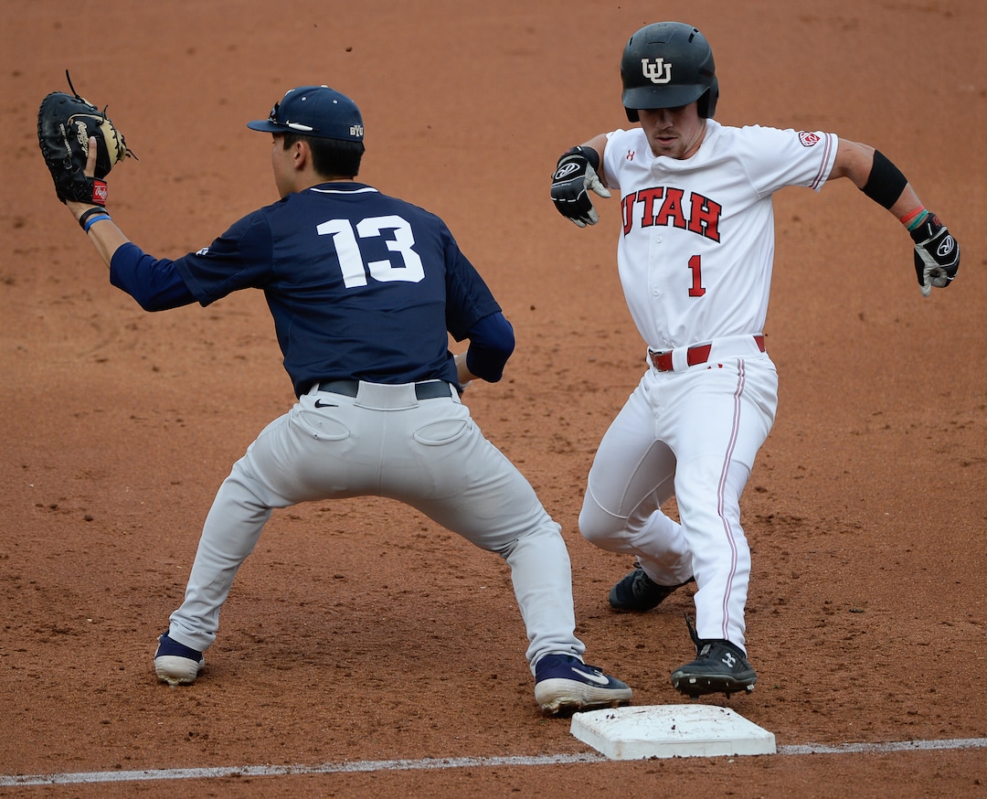 (Francisco Kjolseth  |  The Salt Lake Tribune)  Briley Knight manages to get back to first ahead of Brian Hsu as Utah and BYU renew their rivalry on the baseball diamond as they battle it out at Smith's Ballpark in Salt Lake City on Tuesday, May 14, 2019.