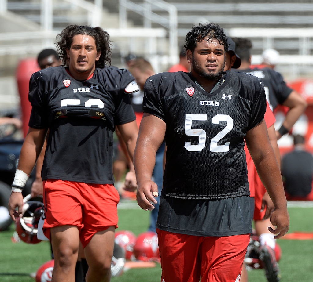 (Al Hartmann  |  The Salt Lake Tribune)  Ute defensive end Bradlee Anae, left, and defensive tackle John Penisini call it a day after practicing Tueday Aug. 15. 